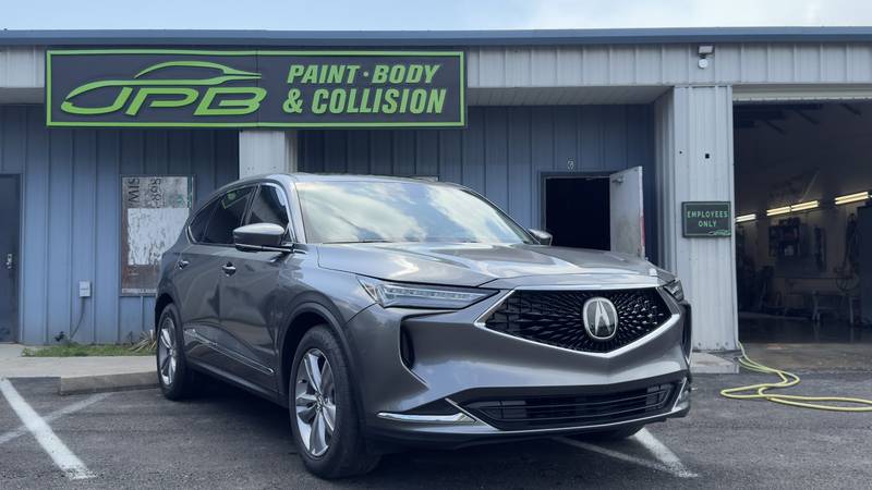 Gray Acura SUV parked in front of the JPB Paint Body & Collision shop